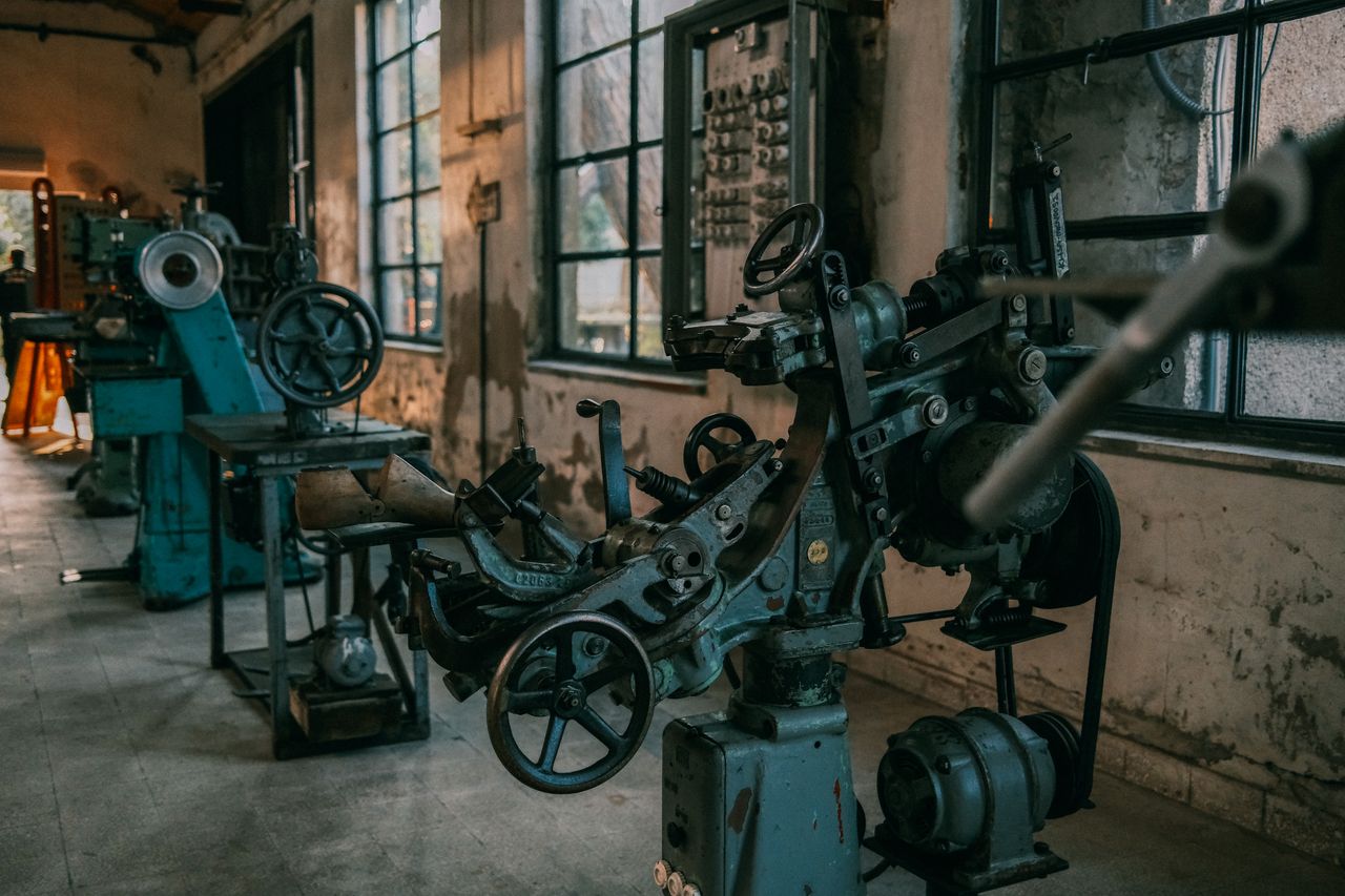 Services Old industrial machines in an abandoned workshop with vintage tools and equipment.